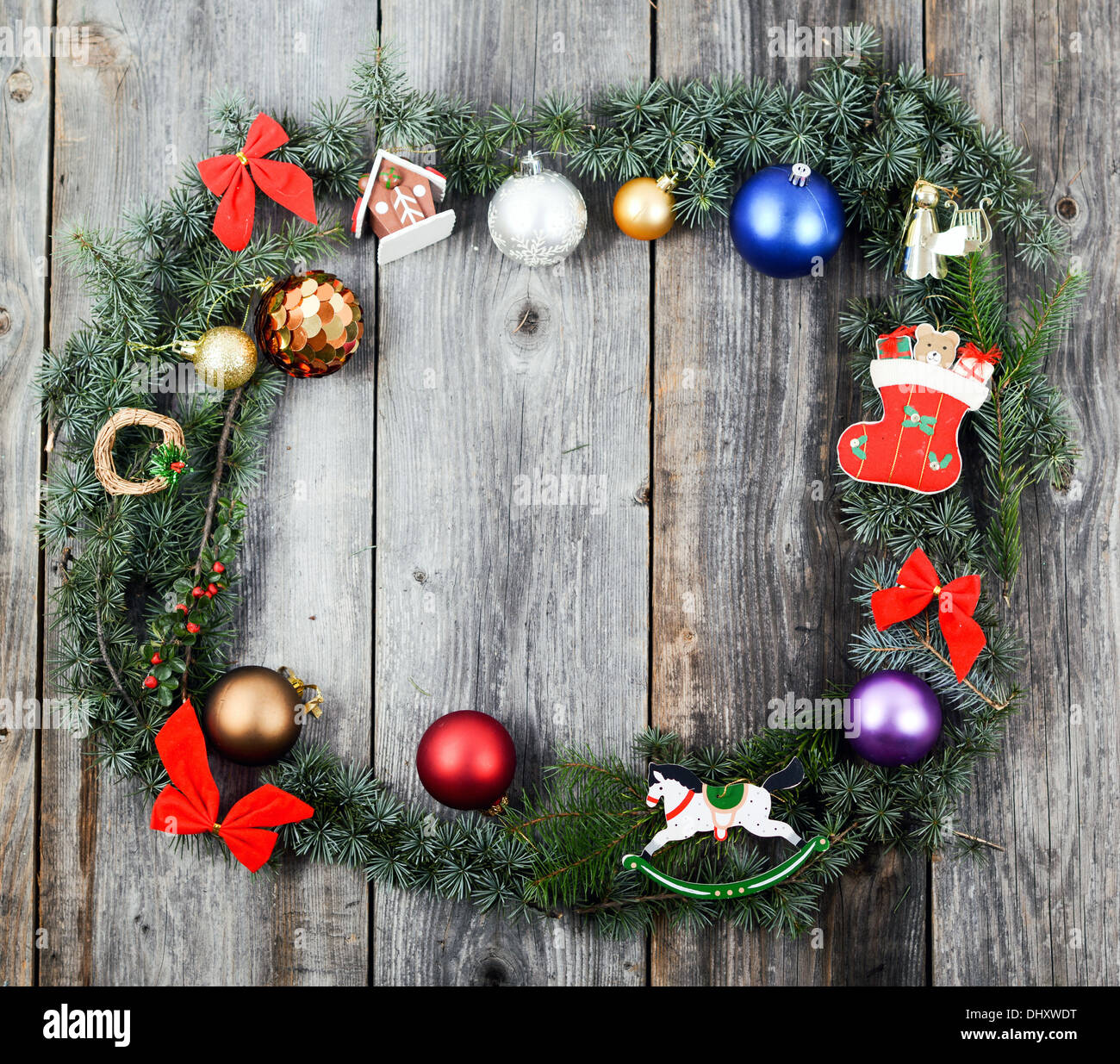 Christmas background with wreath balls and decorations over wooden