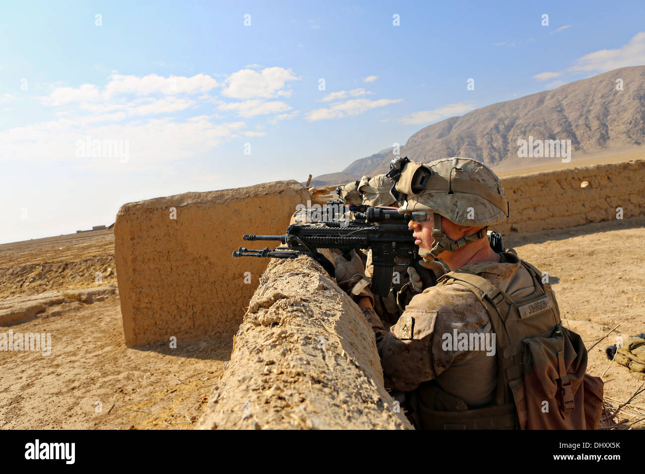 US Marines with the 1st Battalion, 9th Marine Regiment provide security during a clearing mission in a village November 6, 2013 in Helmand province, Afghanistan. Stock Photo