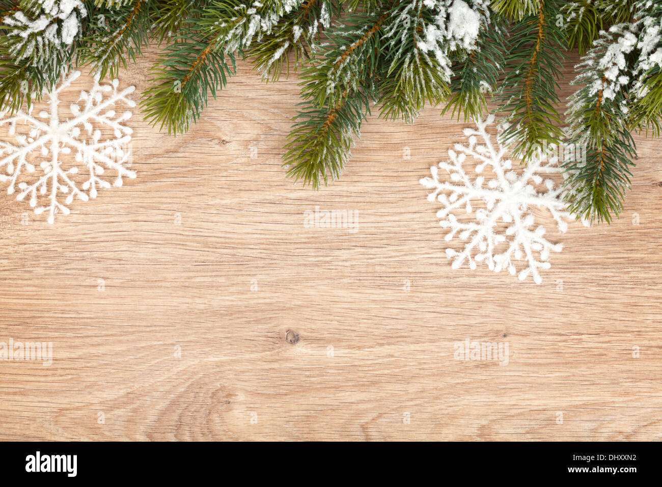 Christmas fir tree covered with snow on wooden board background Stock ...