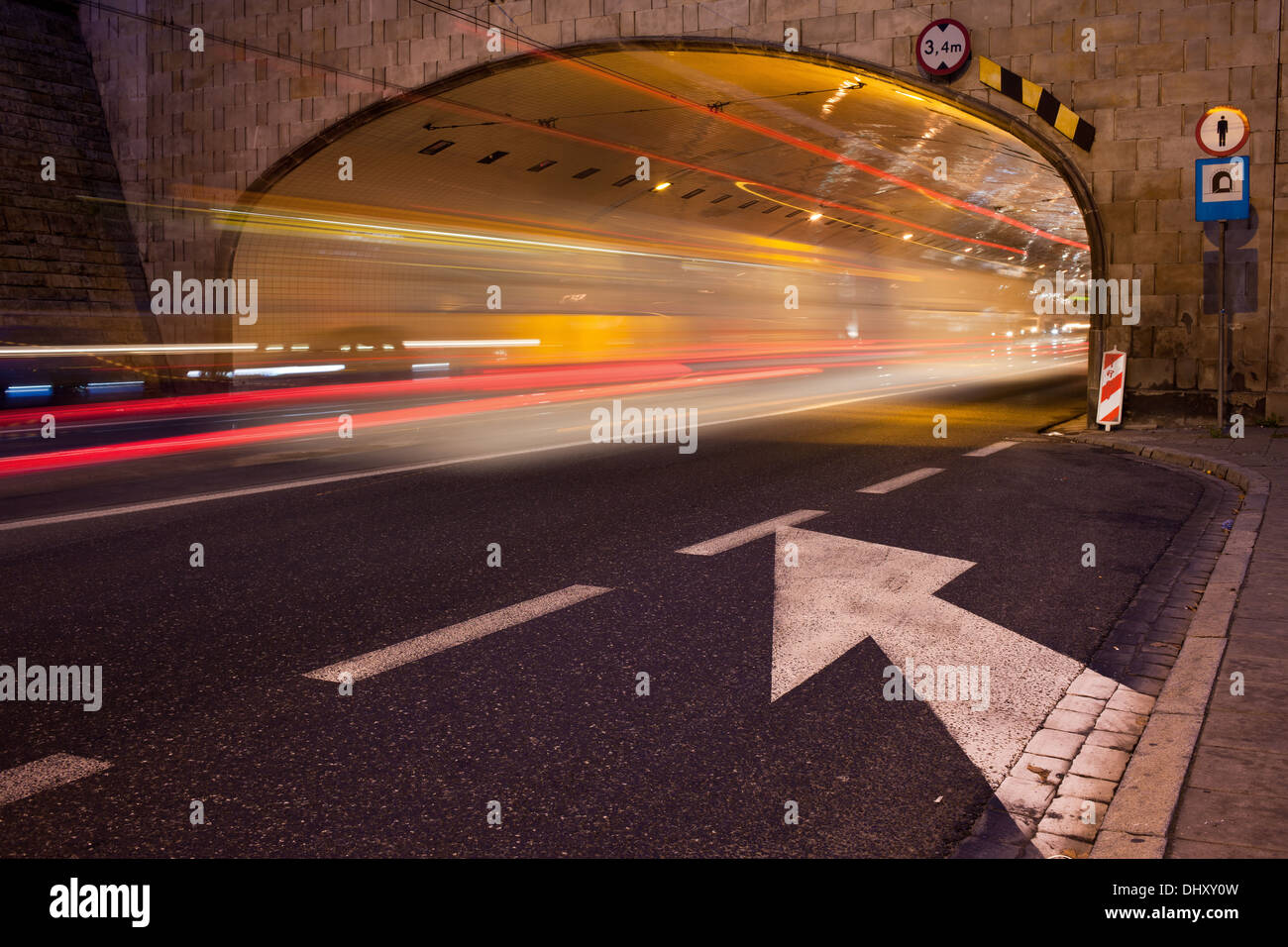 Night traffic light trails on a street under tunnel in Warsaw city center, Poland. Stock Photo