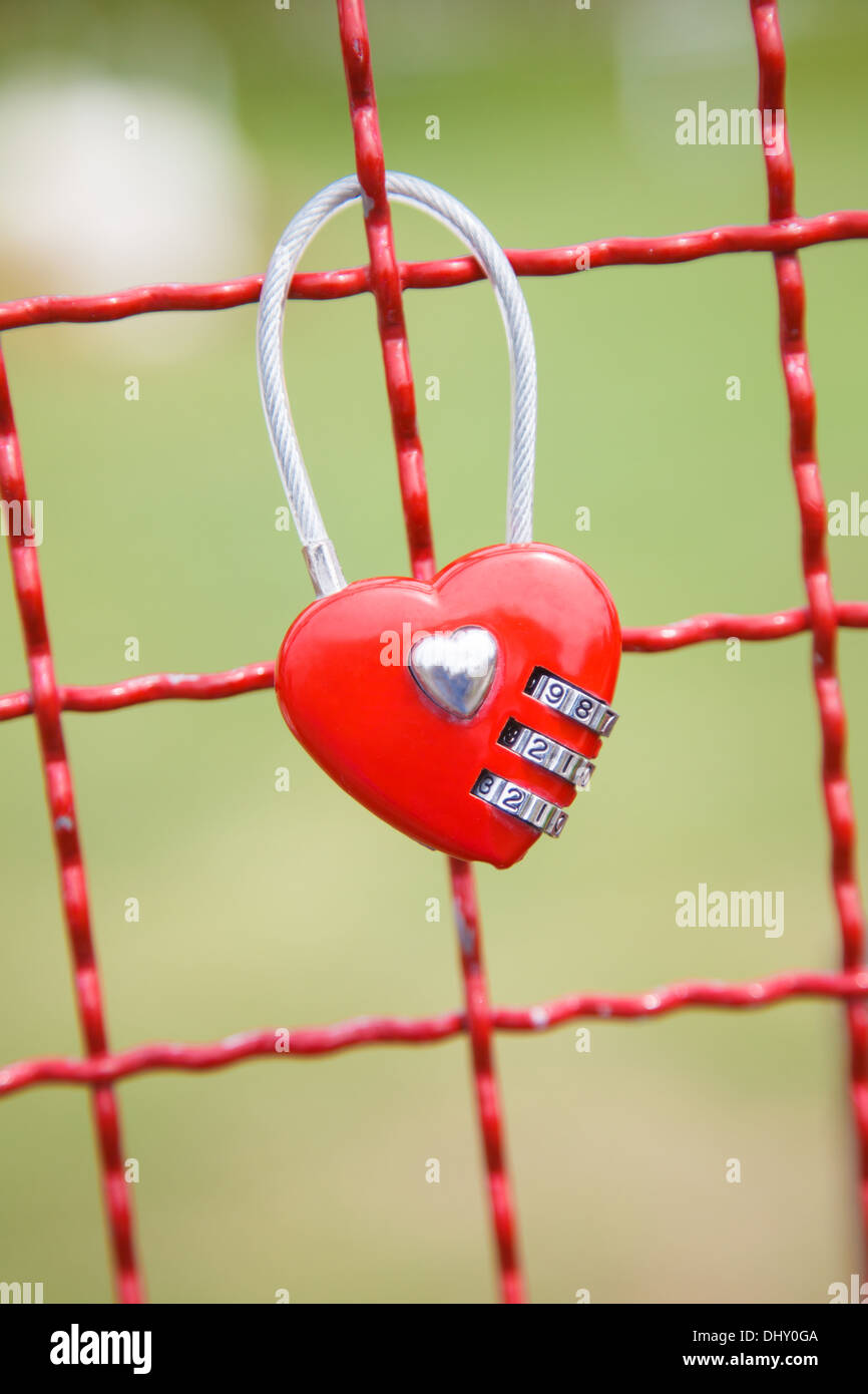 Red padlock Heart Shape on the Fence Stock Photo - Alamy