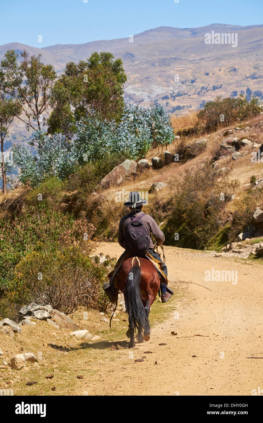 A man riding a horse in the peruvian Andes, South America. Stock Photo