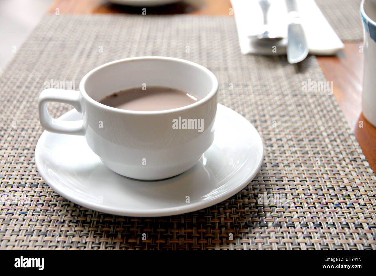White cup of cocoa on the table. Stock Photo