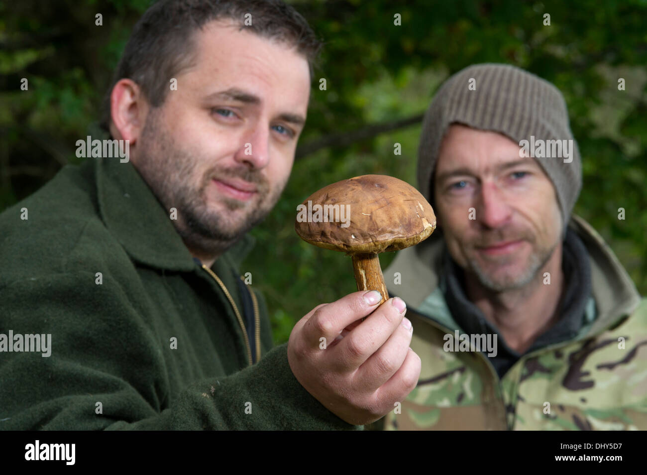 Mushroom foraging on an old landscaped coal mine in Radstock, Somerset, UK with Kris Mouse (green coat) and Fraser Christian (camouflage) Stock Photo