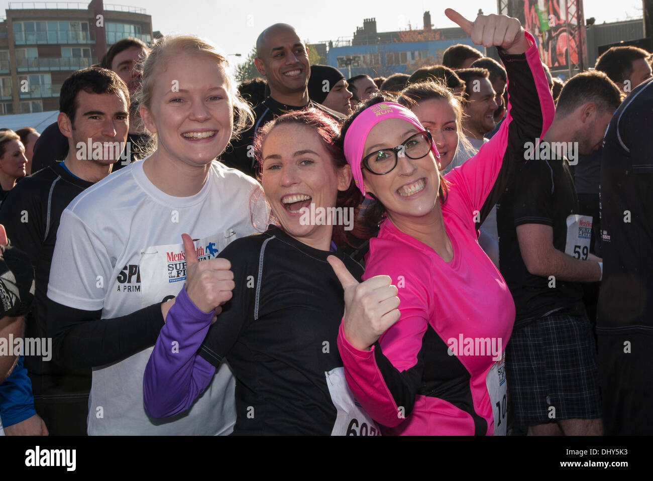 Battersea, London, UK. 16th November 2013. Women warm up before the start at the Men's Health Survival of the Fittest 2013 raceat Battersea Power Station. Credit:  Paul Davey/Alamy Live News Stock Photo