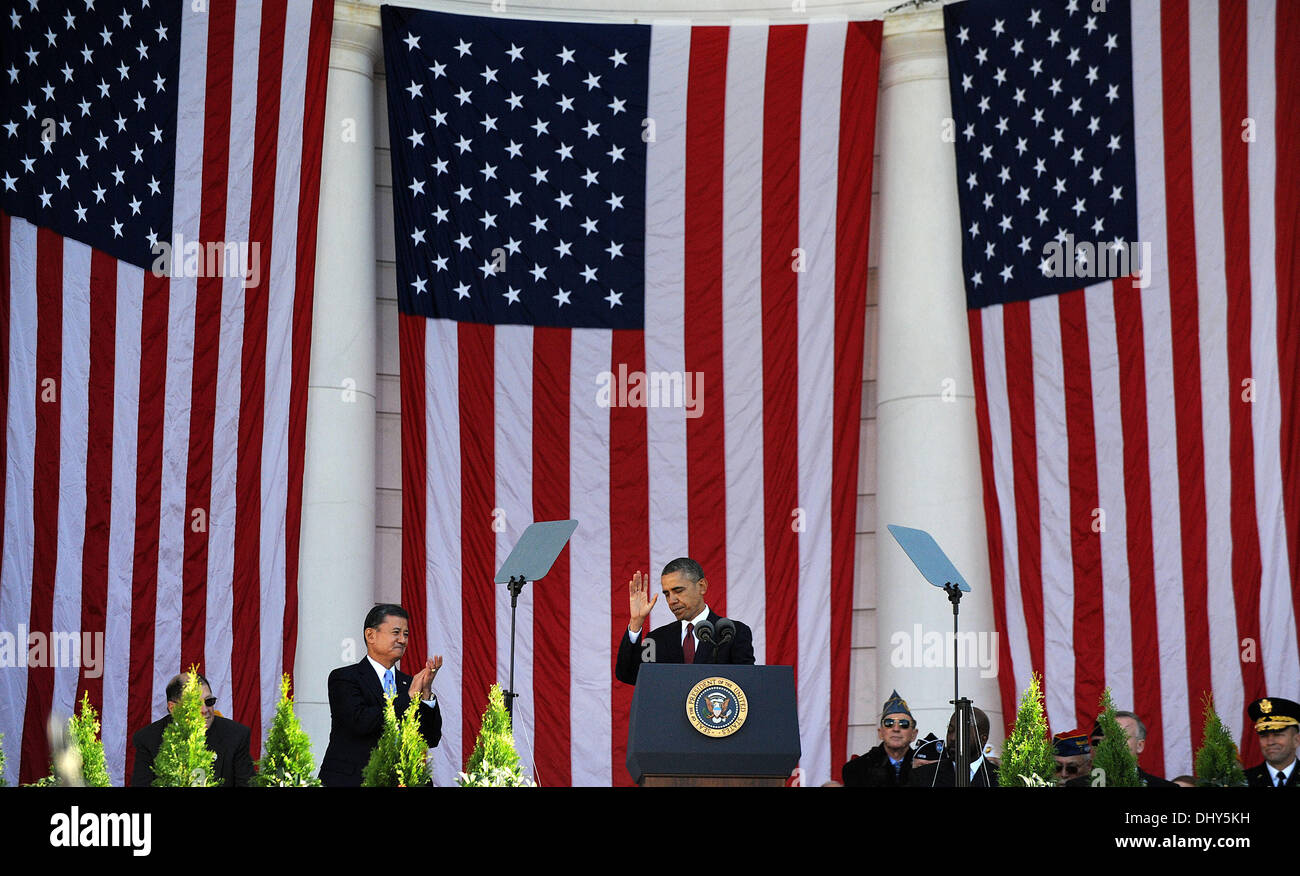 Arlington, Virginia. 11th Nov, 2013. United States President Barack Obama makes remarks during a ceremony to honor veterans at the Memorial Amphitheatre at Arlington National Cemetery on November 11, 2013 in Arlington, Virginia. Applauding at left is United States Secretary of Veterans Affairs Eric Shinseki. Credit: Olivier Douliery / Pool via CNP/dpa/Alamy Live News Stock Photo