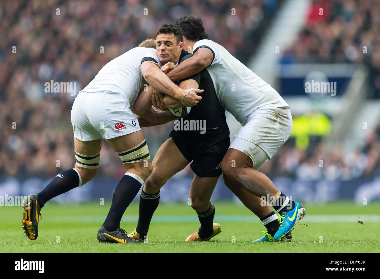 London, UK. 16th Nov, 2013. New Zealand outhalf Dan CARTER tackled during the International Rugby Union fixture between England and New Zealand from Twickenham. Credit:  Action Plus Sports/Alamy Live News Stock Photo