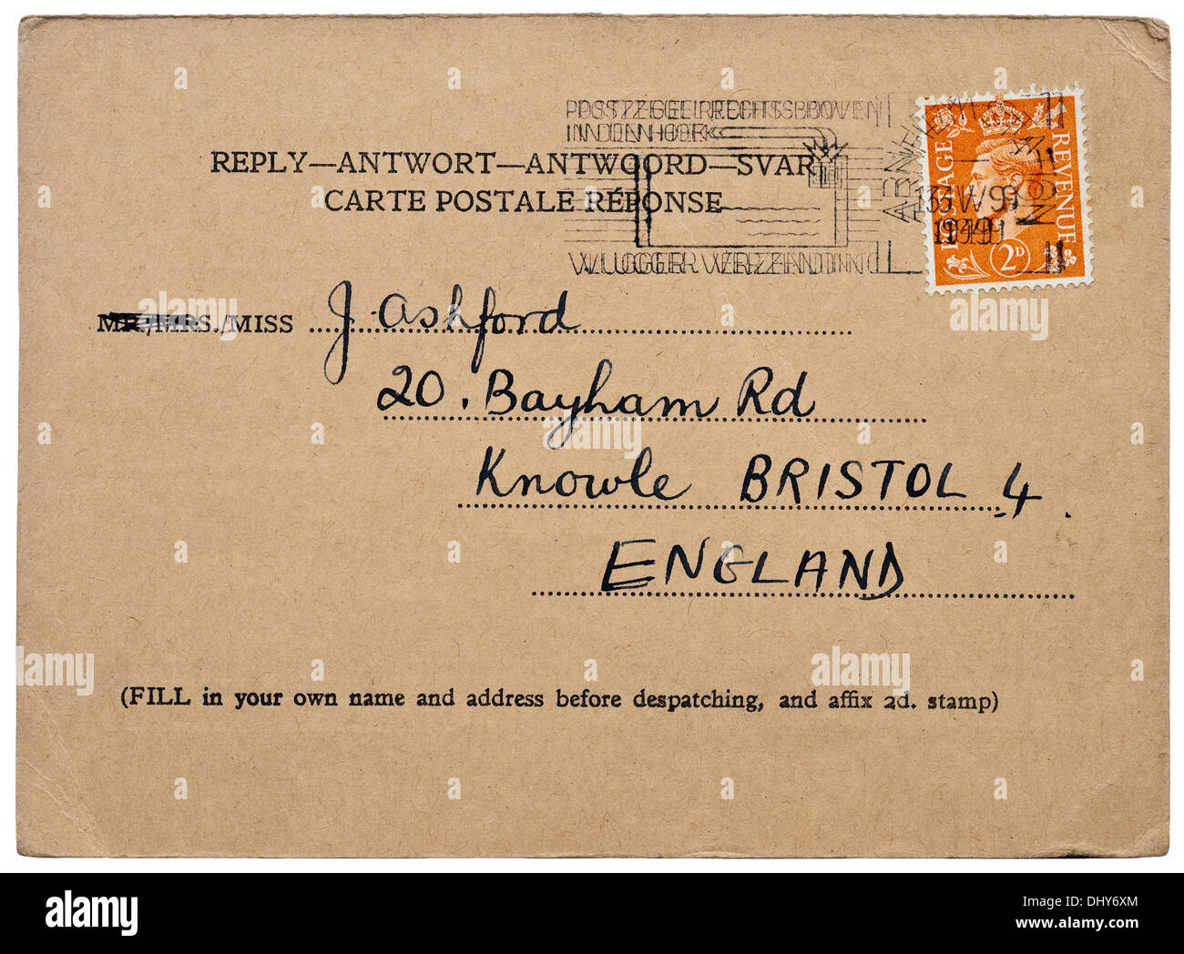 1949 British ordinary surface mail reply-card with 2d orange King George VI stamp addressed to England with Dutch Arnhem cancel. Stock Photo