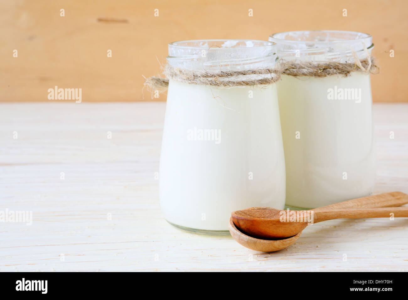 fresh yogurt in a jars on wooden background, food Stock Photo
