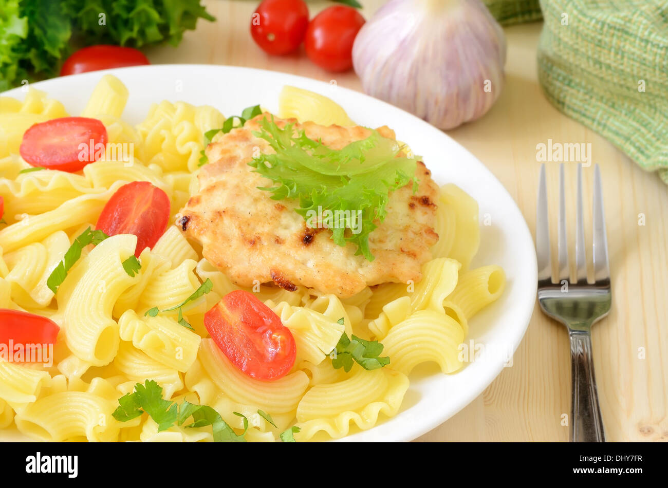 Pasta with tomatoes and chicken cutlet Stock Photo Alamy