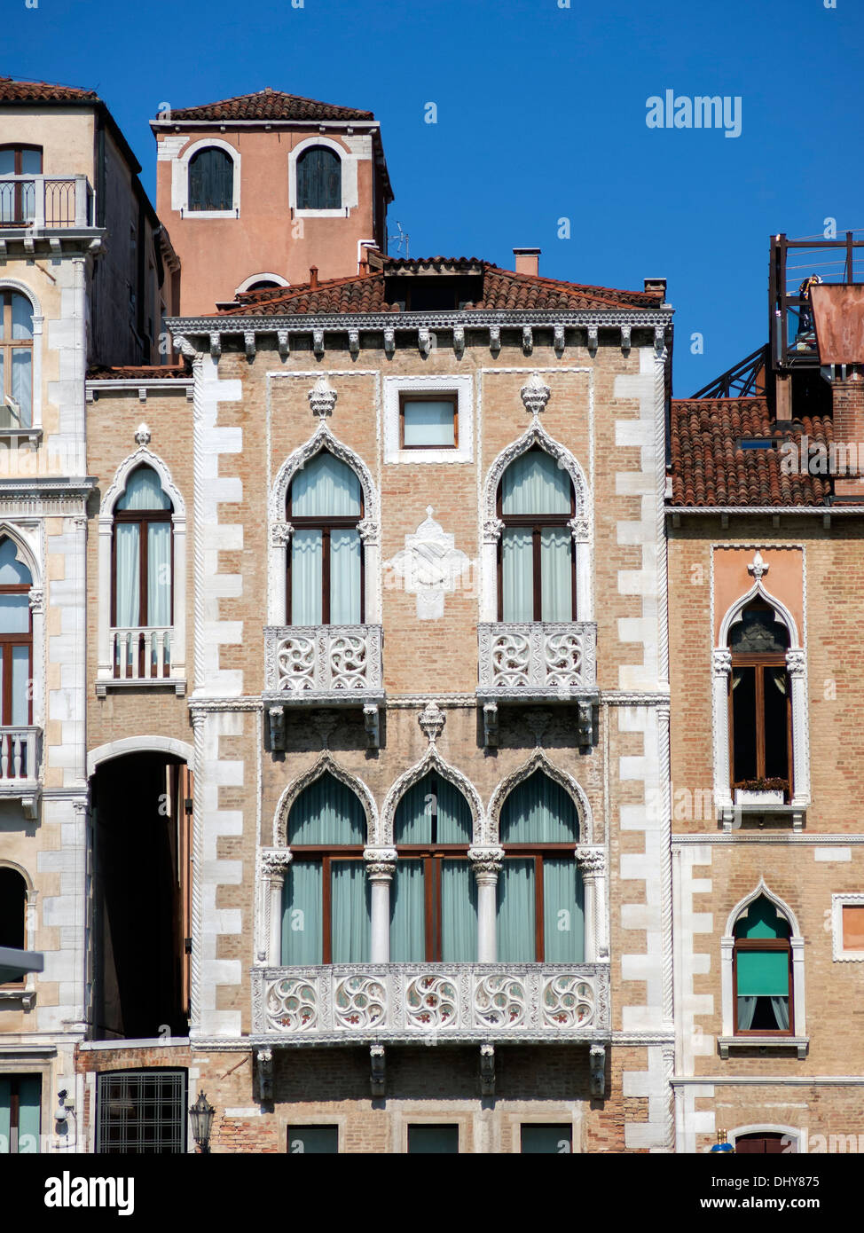 Building facade with decorated white stone ogee arch windows and ornate stone balconies, Venice, Italy. Stock Photo