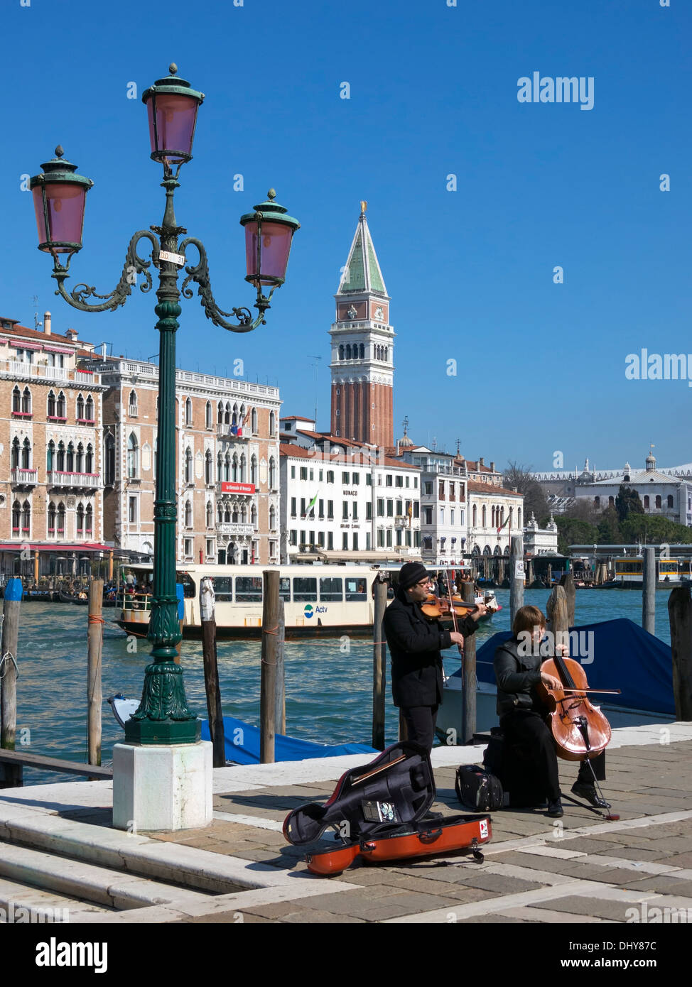 Grand Canal, buskers, ornate street lamp, Campanile Tower, Salute, Venice, Italy. Stock Photo