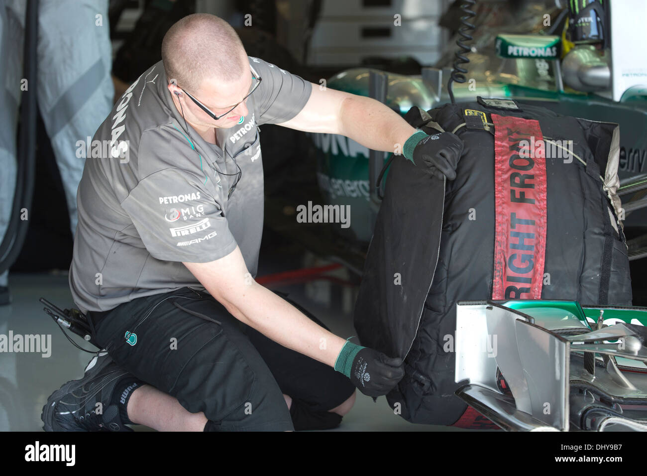 Mercedes AMG Petronas team mechanic checks heated tires of car during practice session for United States Grand Prix Stock Photo