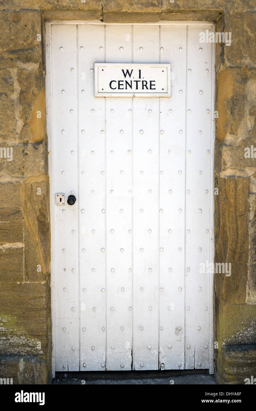 White wooden studded door entrance to the Women's Institute meeting hall Stock Photo