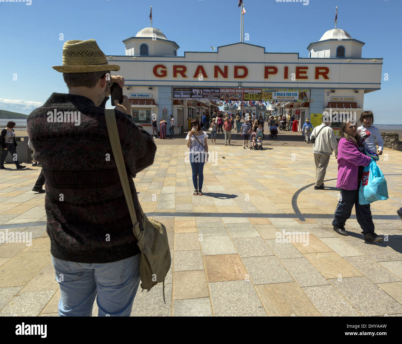 Man taking photo in front of Grand Pier entrance Weston-Super-Mare Stock Photo