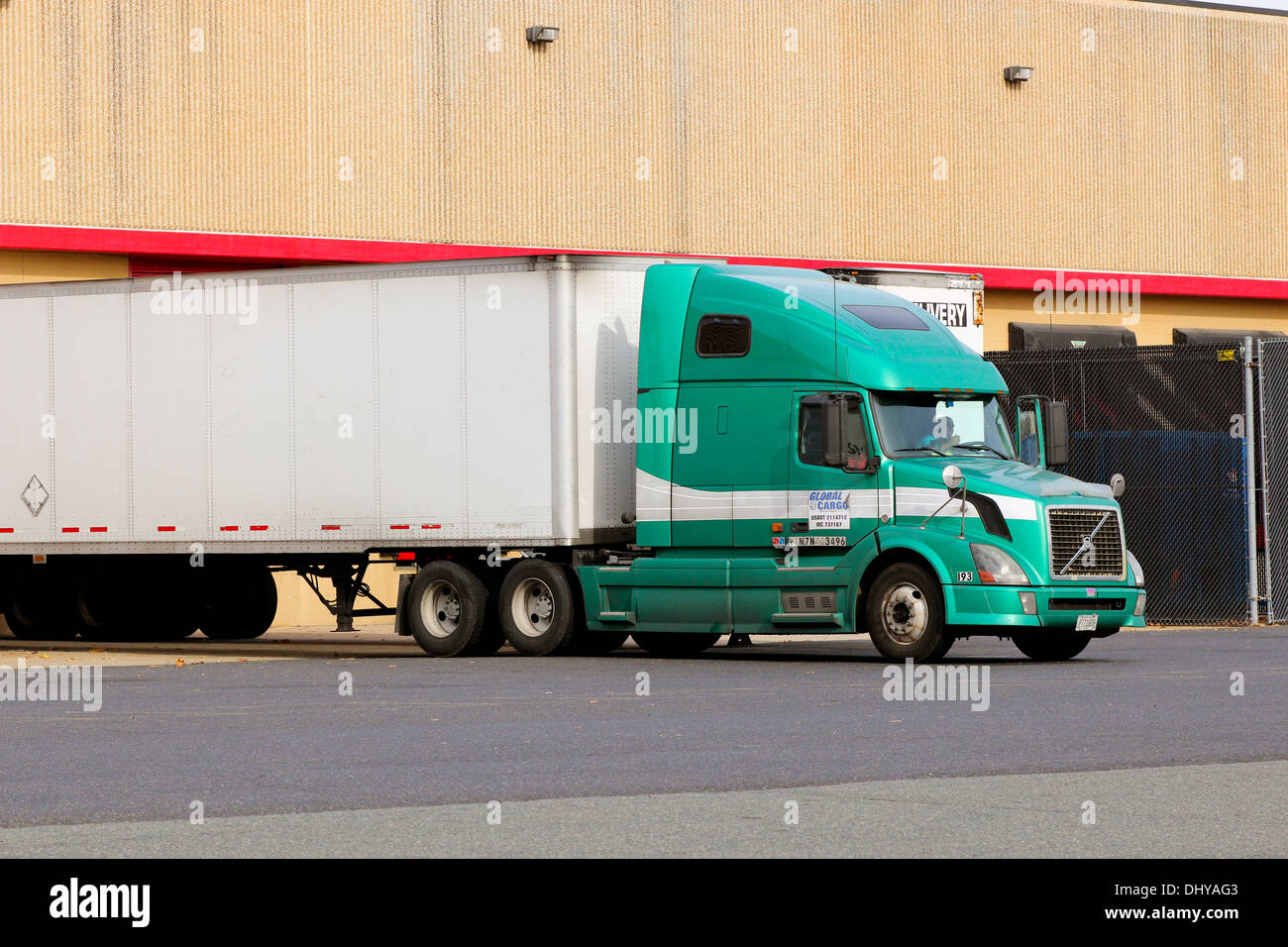 Truck lorry semi tractor trailer backed up to a loading dock Stock