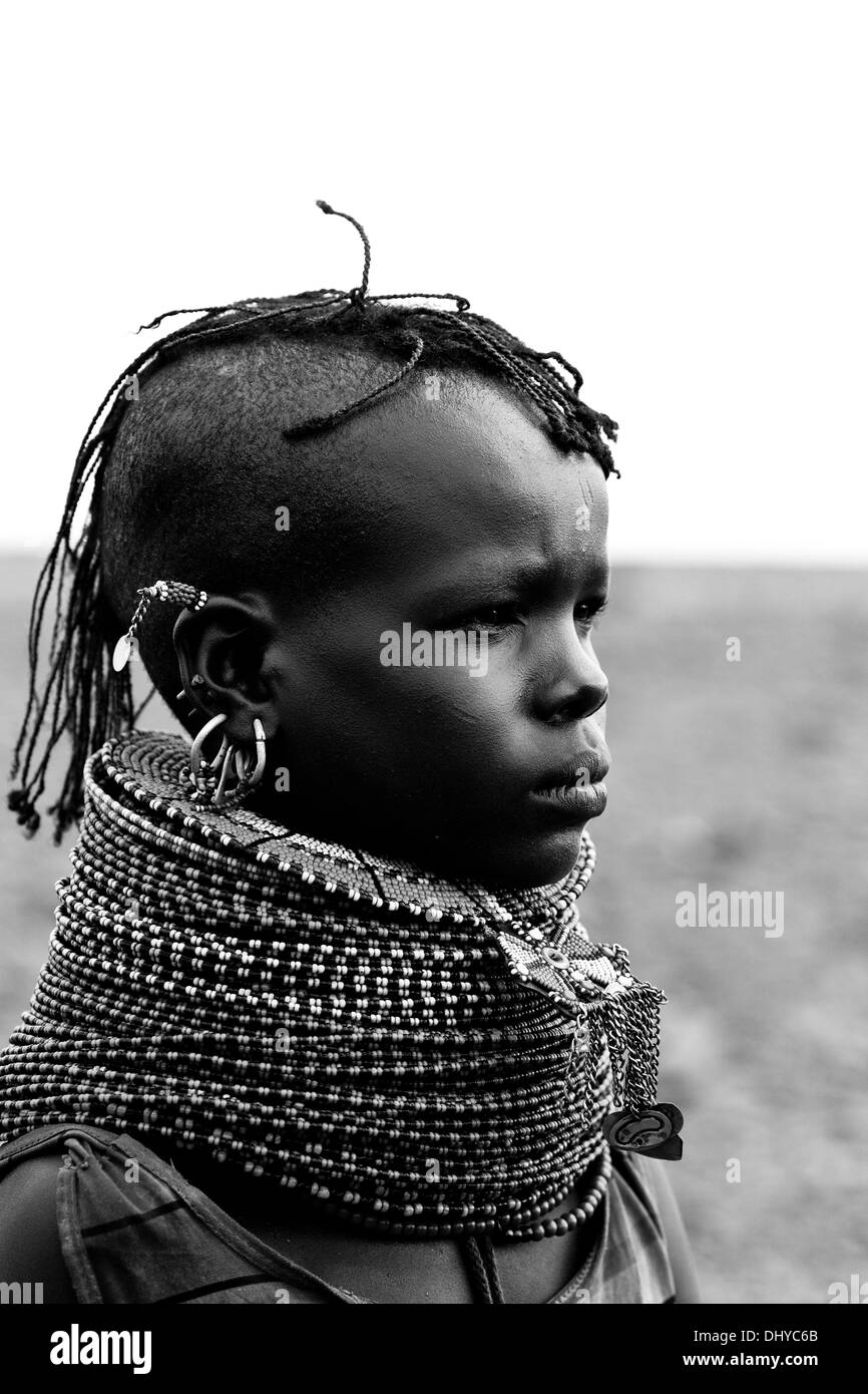 Portrait of a teenage Turkana girl in traditional attire, in a remote Turkana village near Loiyangalani, Lake Turkana, Kenya. Stock Photo