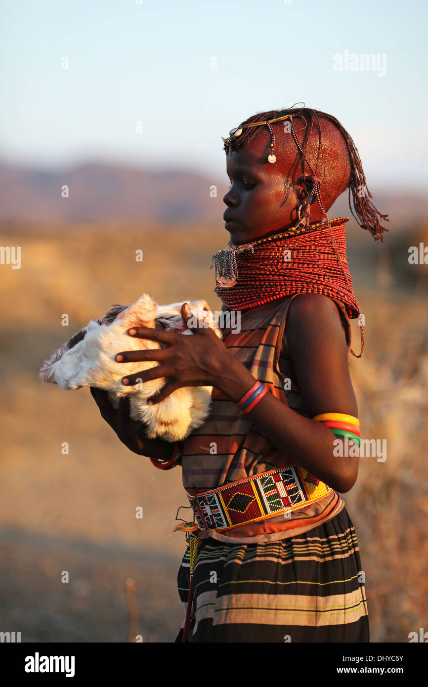 A teenage Turkana girl in traditional attire, in a remote Turkana village near Loiyangalani, Lake Turkana, Kenya. Stock Photo