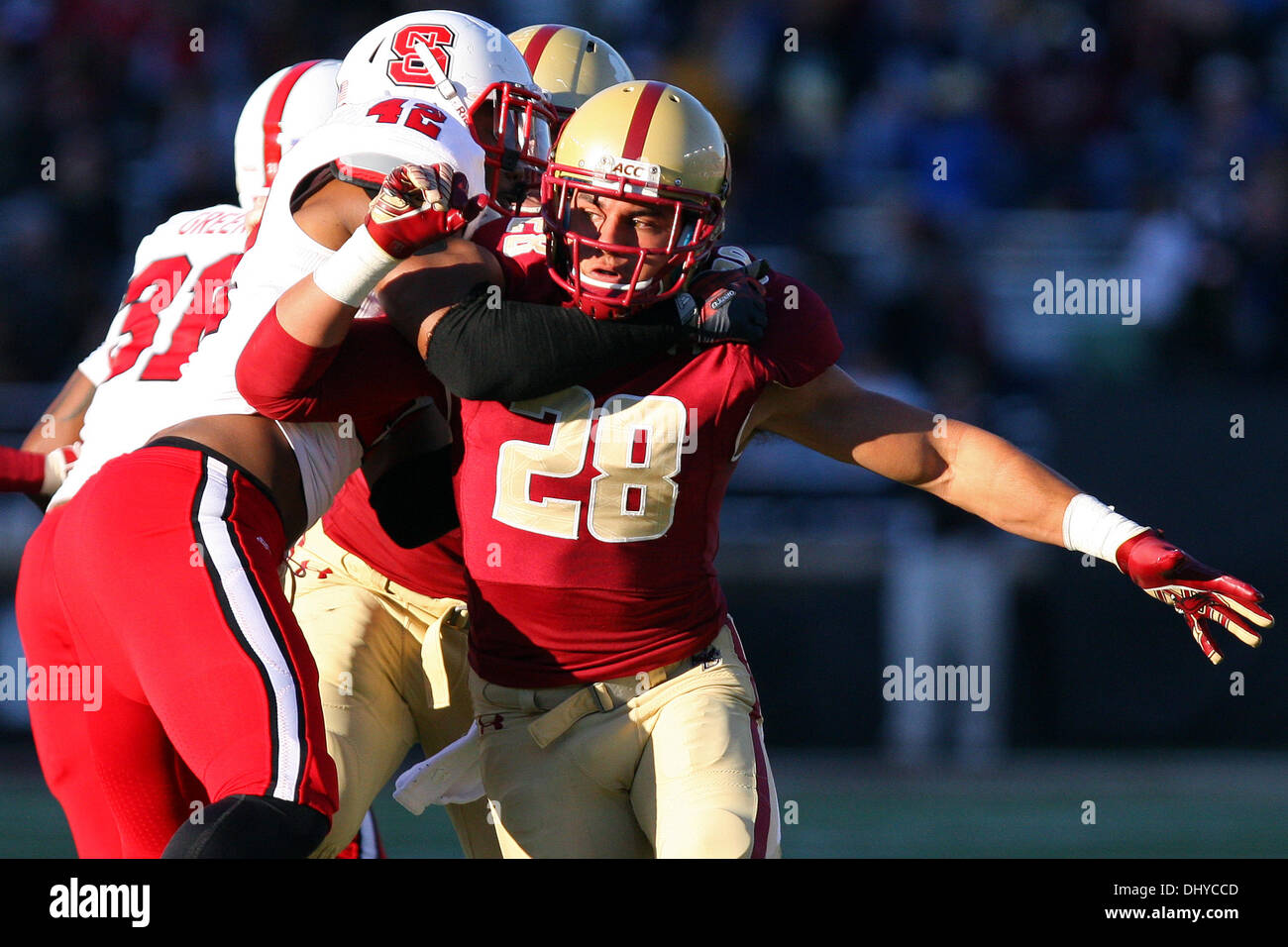 Chestnut Hill, Massachusetts, USA. 16th Nov, 2013. November 16, 2013: North Carolina State Wolfpack linebacker M.J. Salahuddin (42) and Boston College Eagles safety Matt Milano (28) in action during the NCAA football game between the Boston College Eagles and North Carolina State Wolfpack at Alumni Stadium. Boston College defeated North Carolina State 38-21 and becomes bowl eligible. Anthony Nesmith/CSM/Alamy Live News Stock Photo