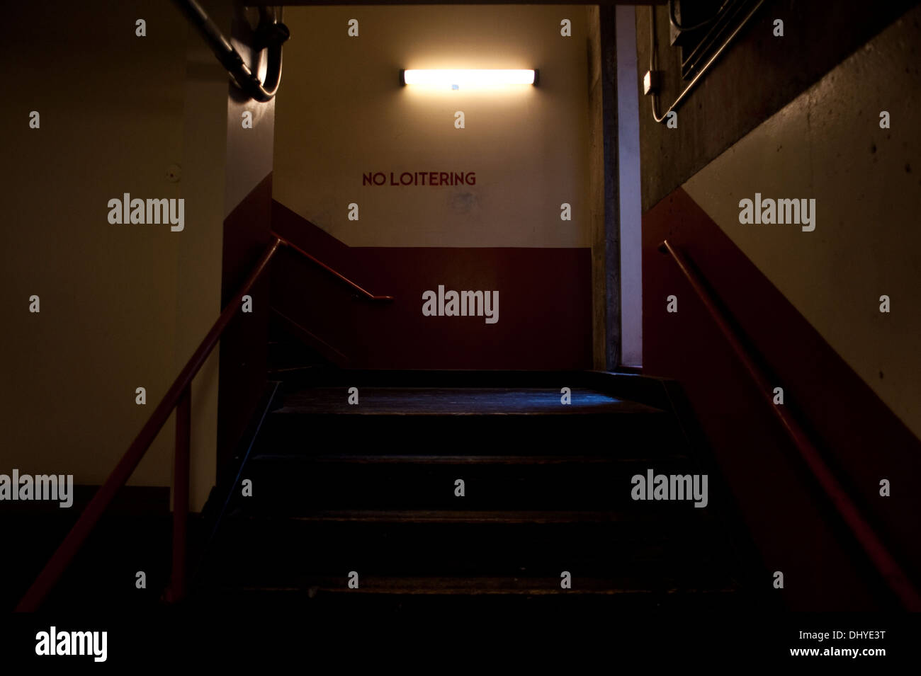 Dark interior with stairs and no loitering sign at Post Alley Pike Place Market Stock Photo