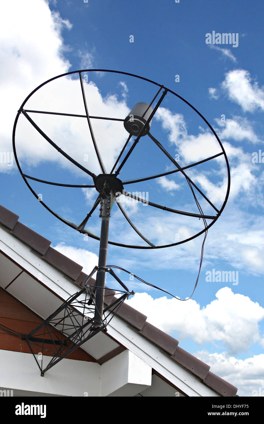 The Picture Satellite dish Stuck to roof of house on Blue sky. Stock Photo