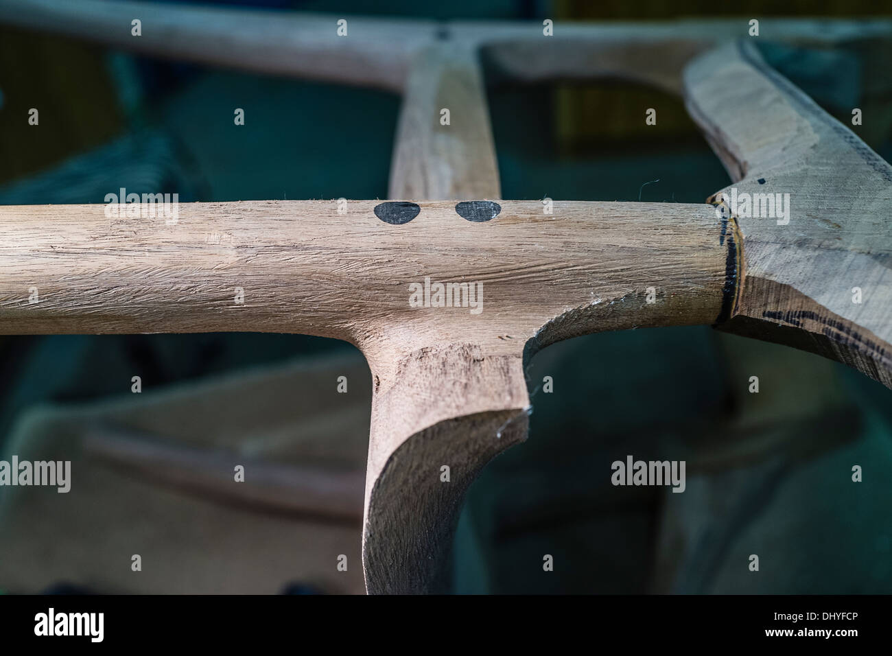 Closeup of a wood joint on a chair during construction at the shop of