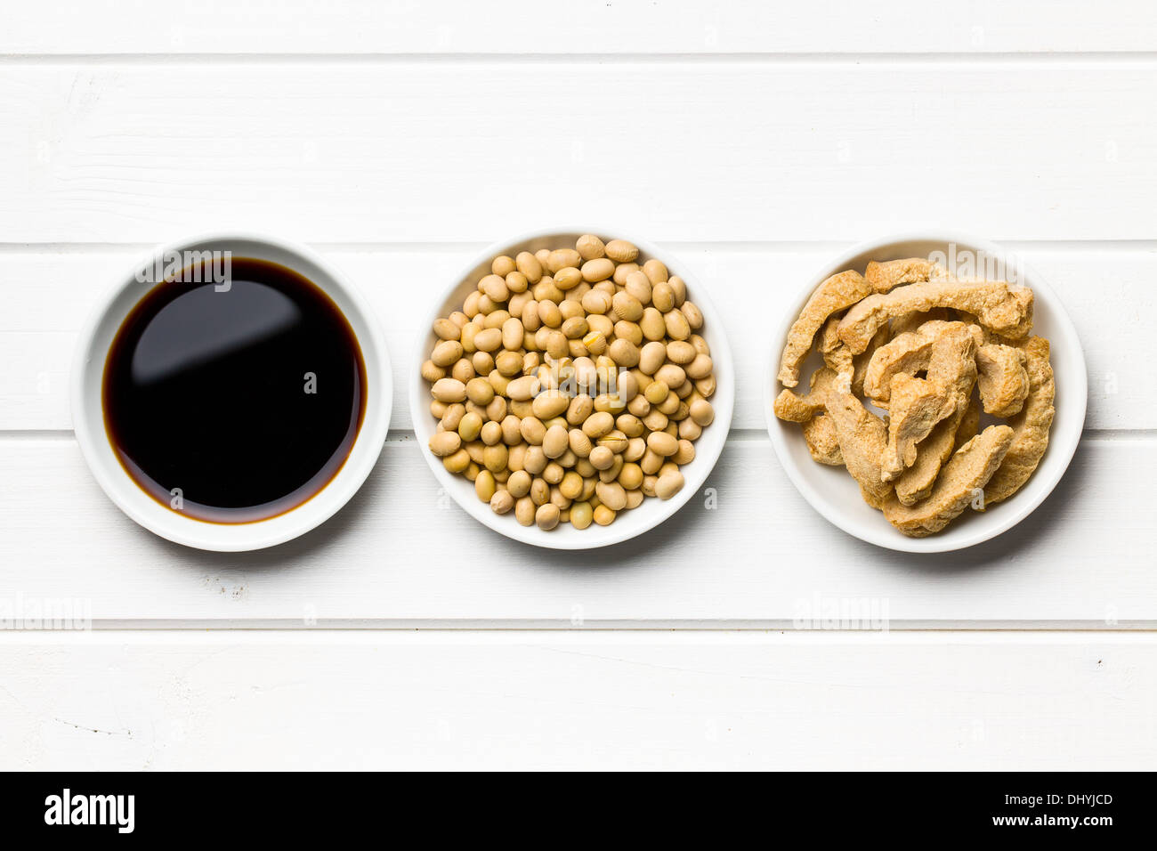soy sauce, soybeans and soy meat in bowls on wooden table Stock Photo
