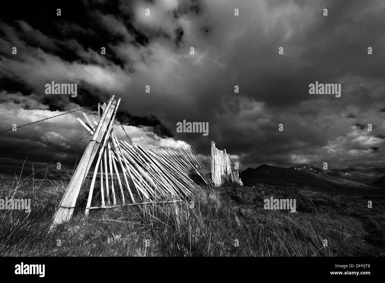 Broken wooden fence posts against the backdrop of the Northern Scottish Highlands just off the A835 Inverness to Ullapool road. Stock Photo