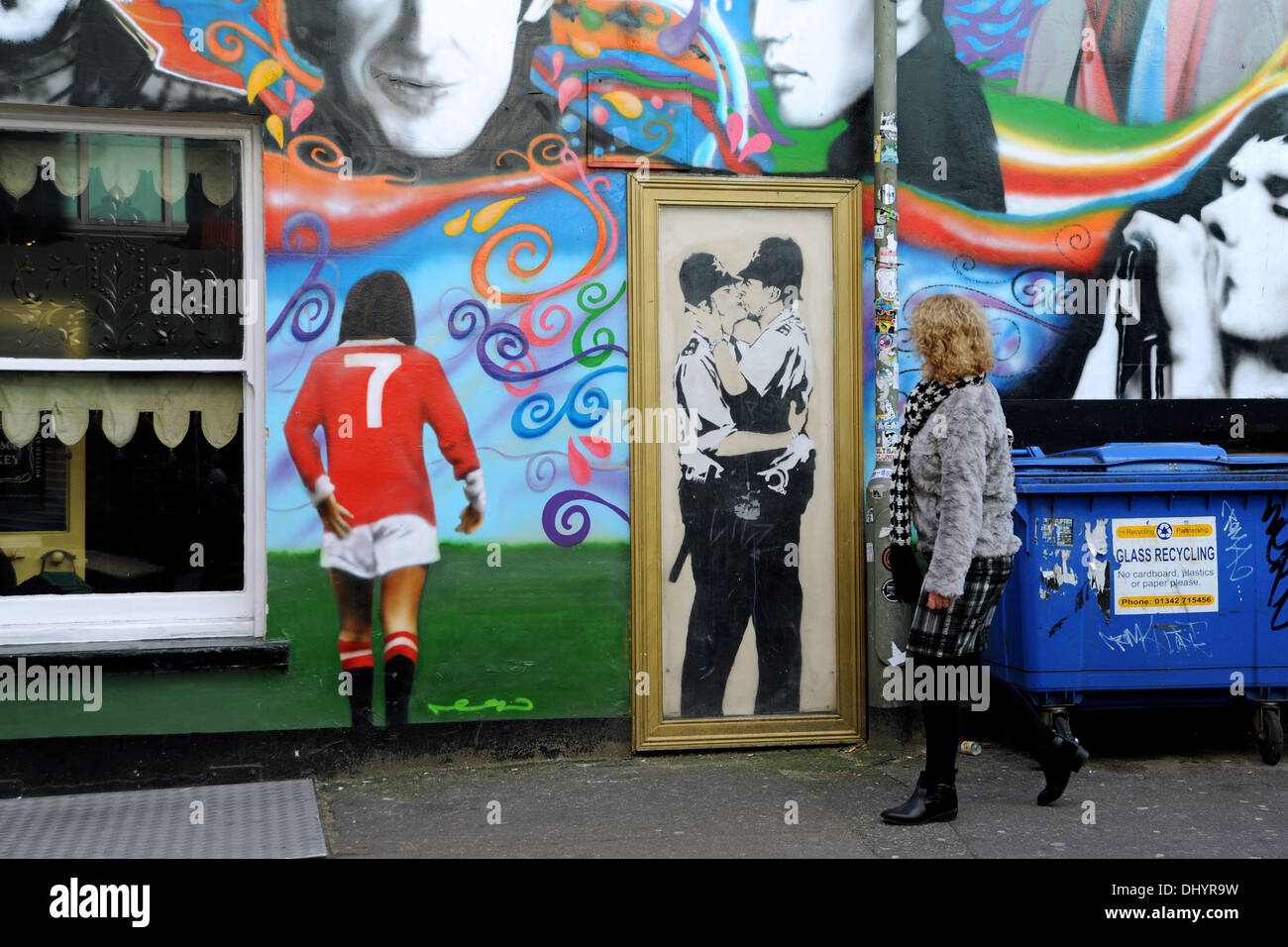 A canvas copy of Banksy graffiti art of the two Kissing Policemen (Kissing Coppers) on wall at Prince Albert Pub in Brighton UK  plus George Best - Stock Photo