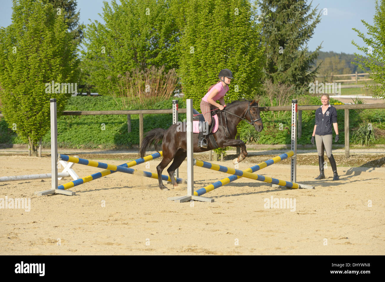 Beginner's jumping lesson, girl on pony Stock Photo