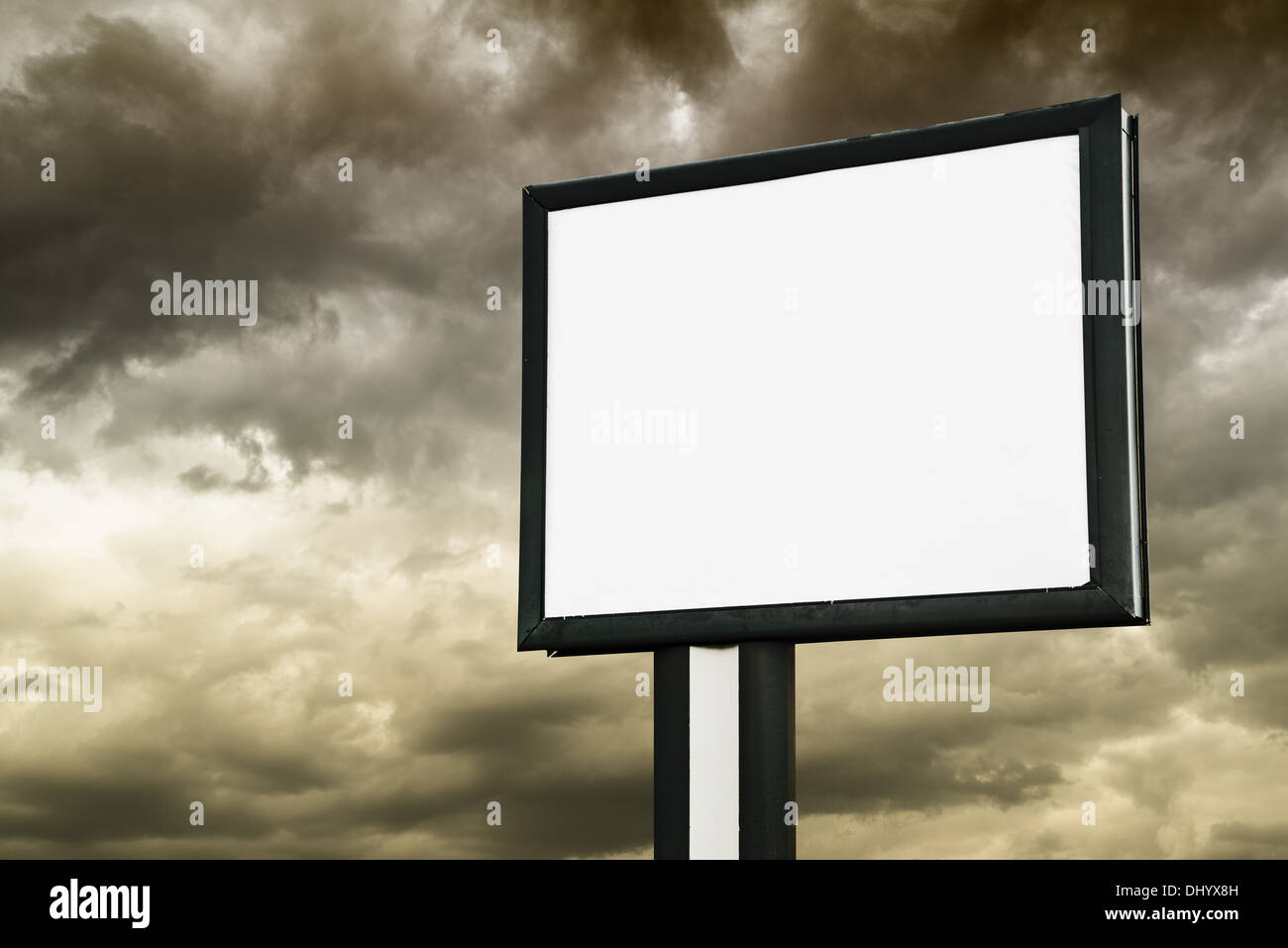 Blank Billboard with empty screen over dark stormy clouds Stock Photo