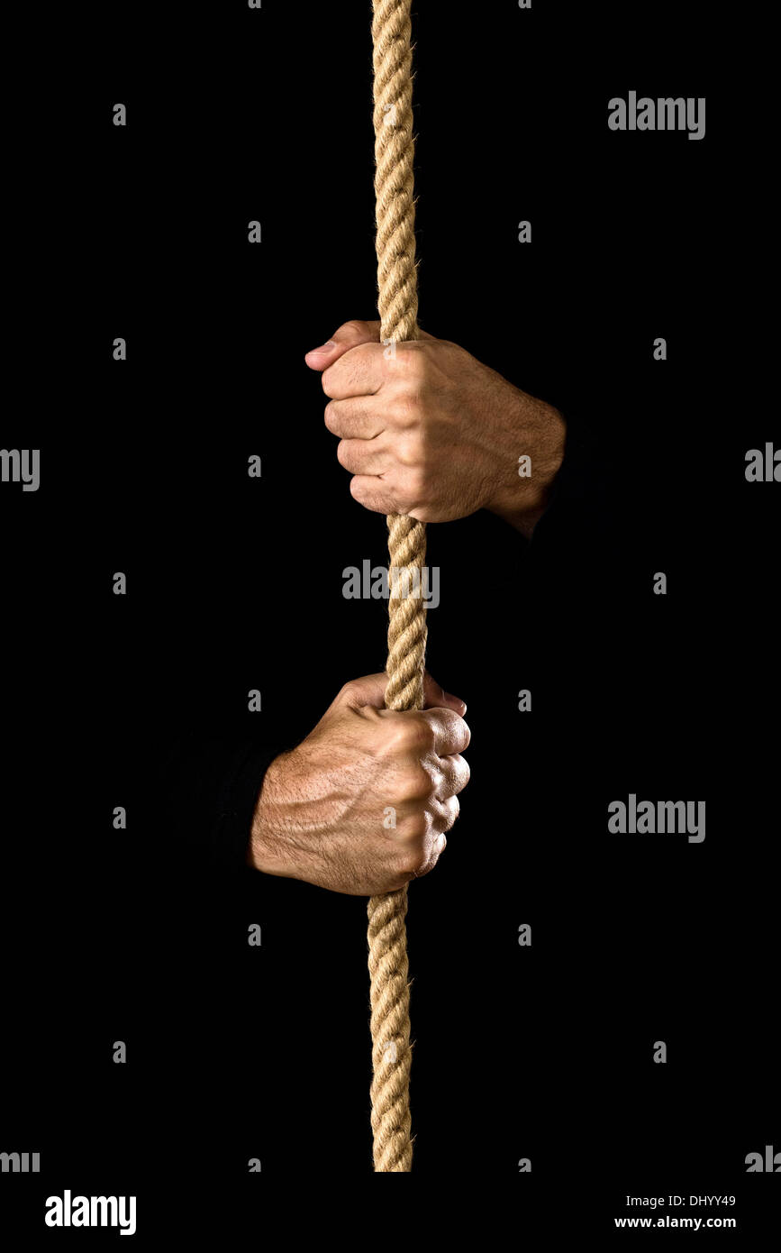 Hands holding a rope, strength and determination concept. Stock Photo