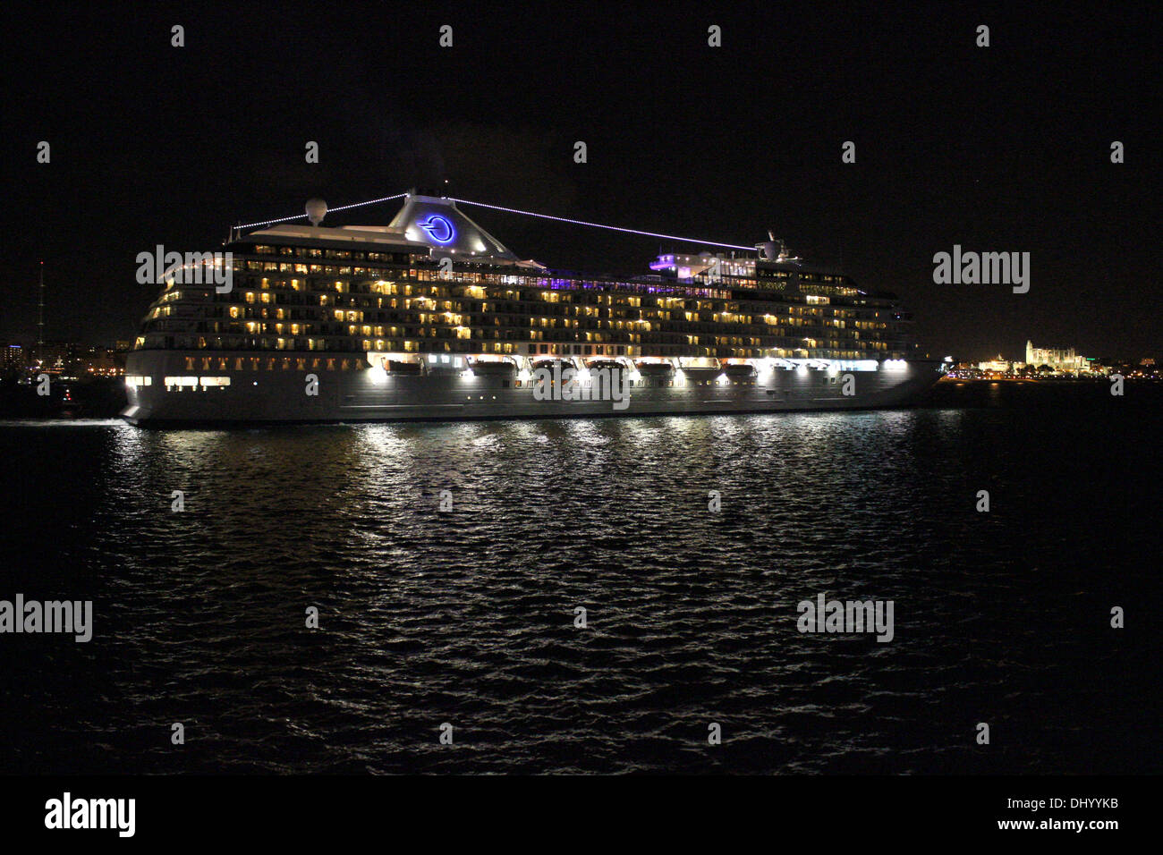 Oceania Cruises Cruise Ship 'Marina' (238 mtrs) during night departure - about to pass the historic Palma Gothic Cathedral Stock Photo