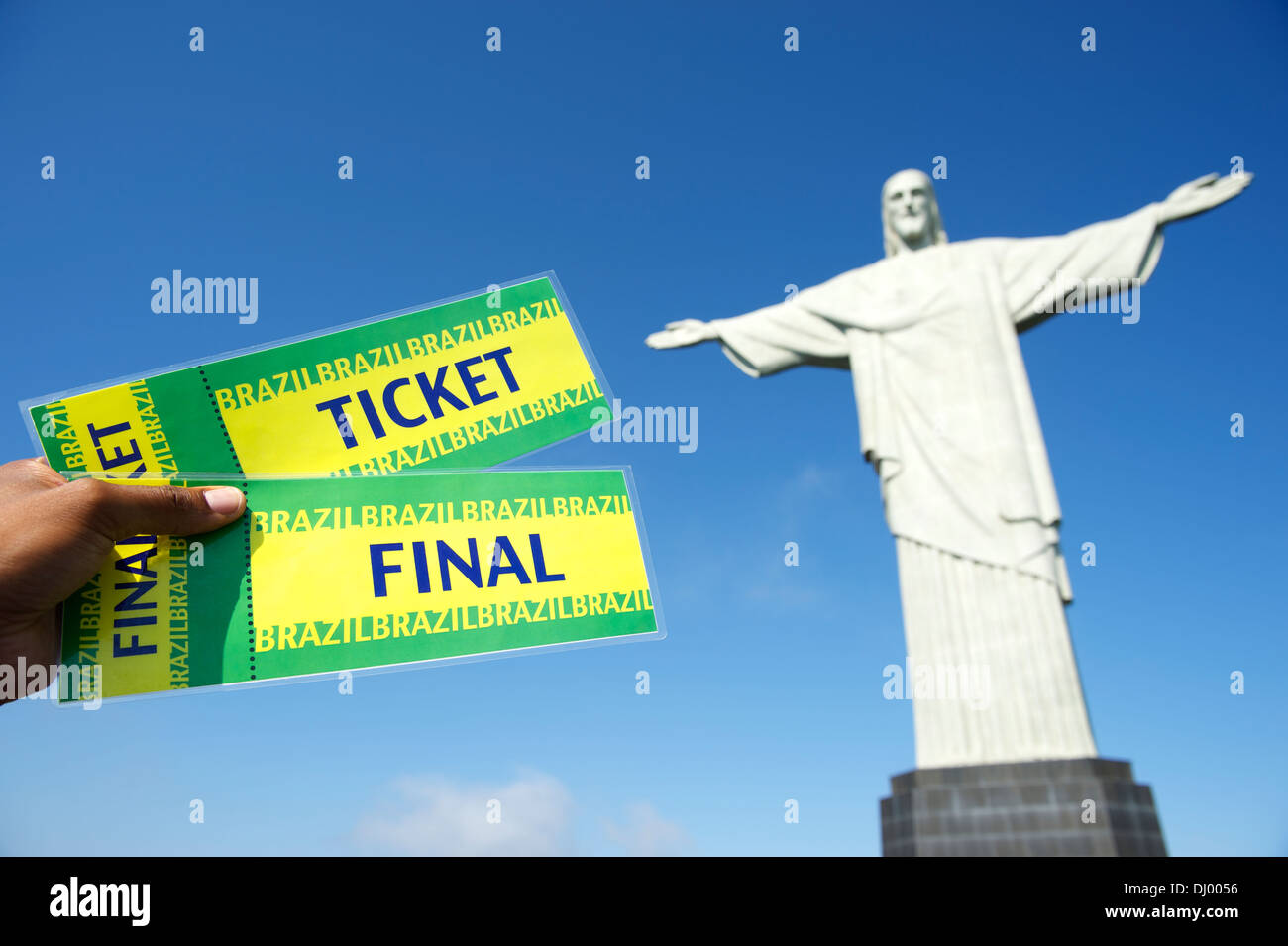 Brazilian hand holds pair of tickets to the final soccer match at Corcovado in Rio de Janeiro Stock Photo