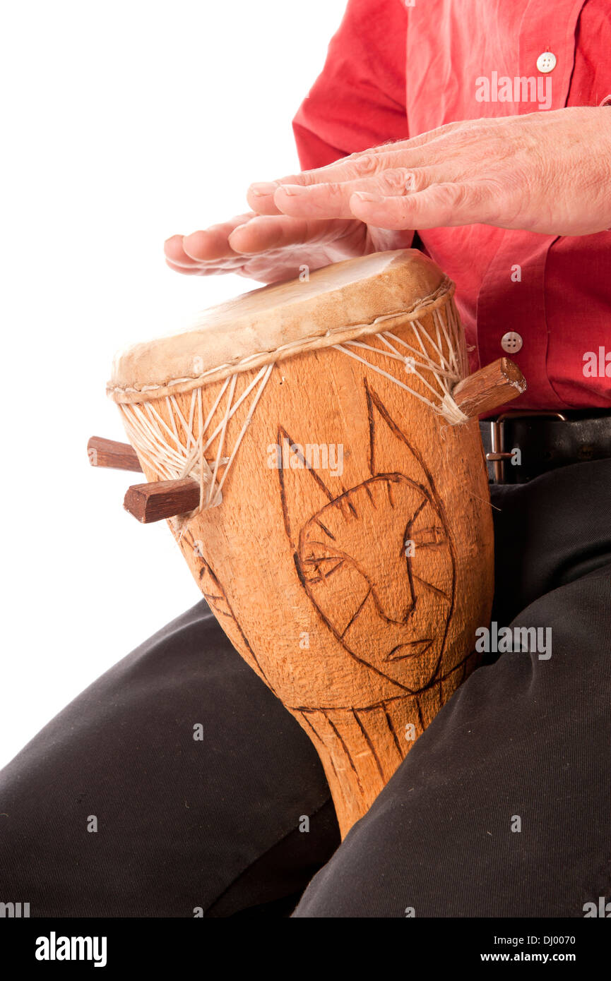 Man playing and drumming on African drum on his lap Stock Photo