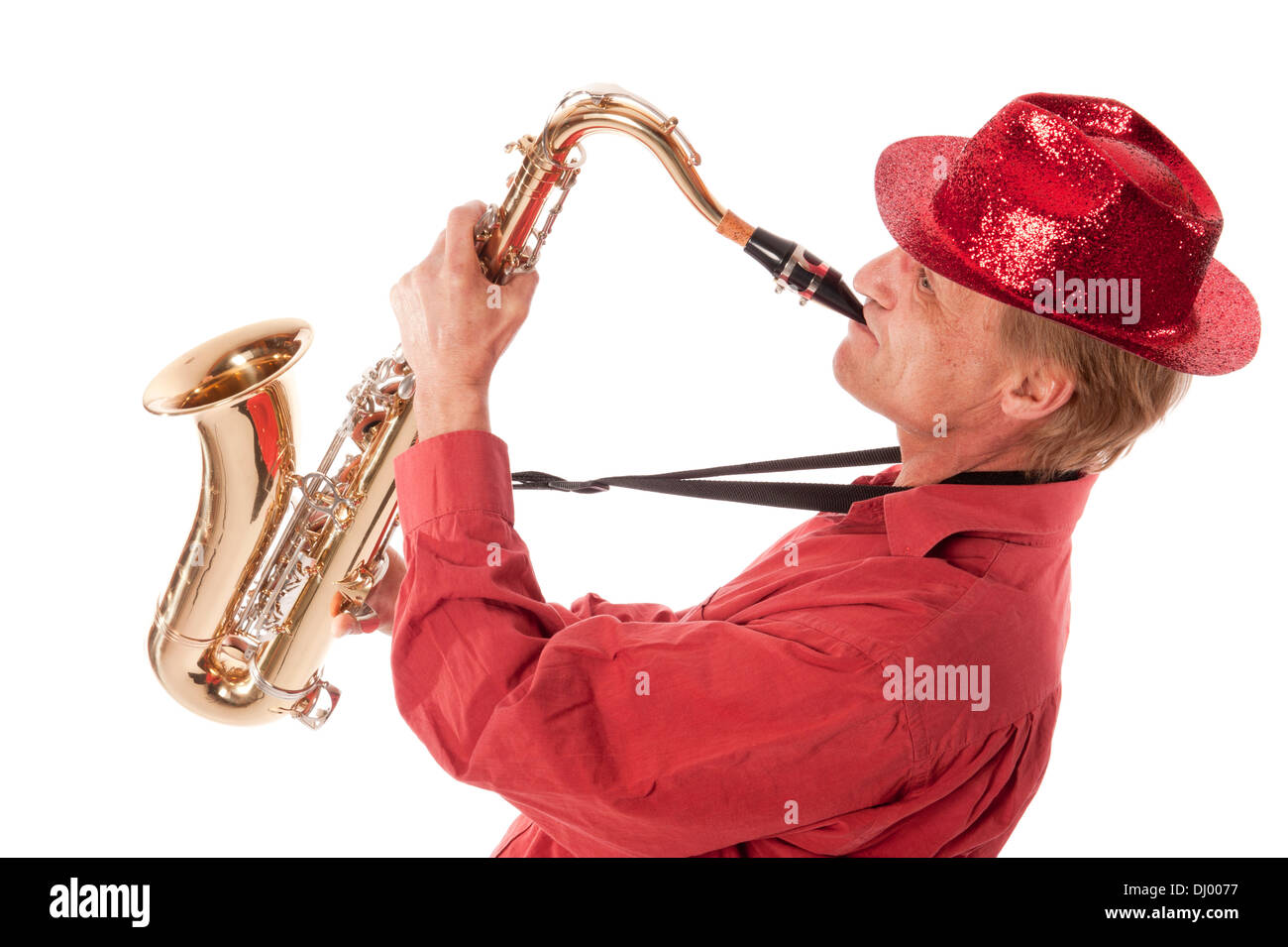 Male entertainer playing a brass tenor saxophone with silver valves and pearl buttons leaning backwards Stock Photo