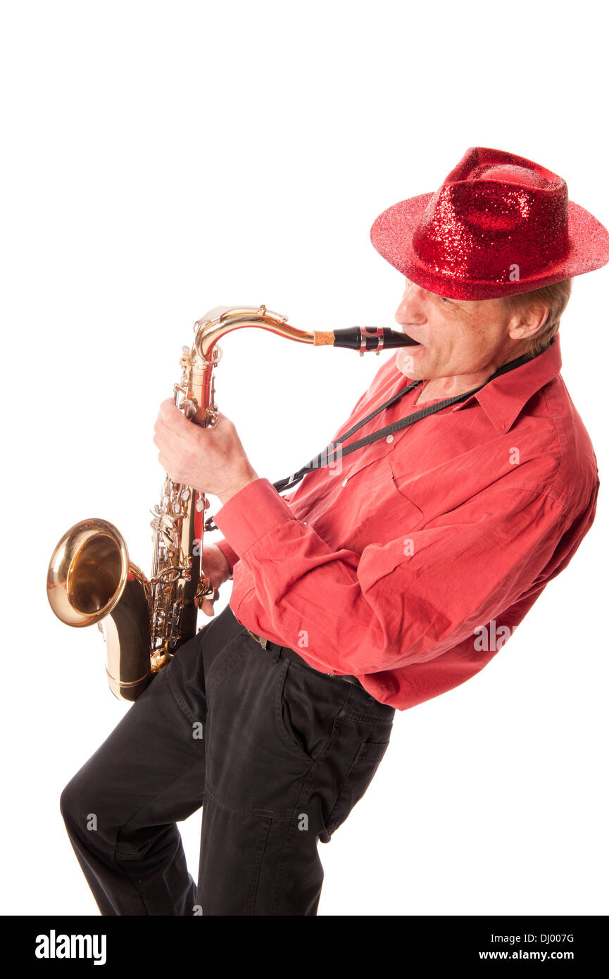 Male artist playing a brass tenor saxophone with silver valves and pearl buttons leaning backwards Stock Photo