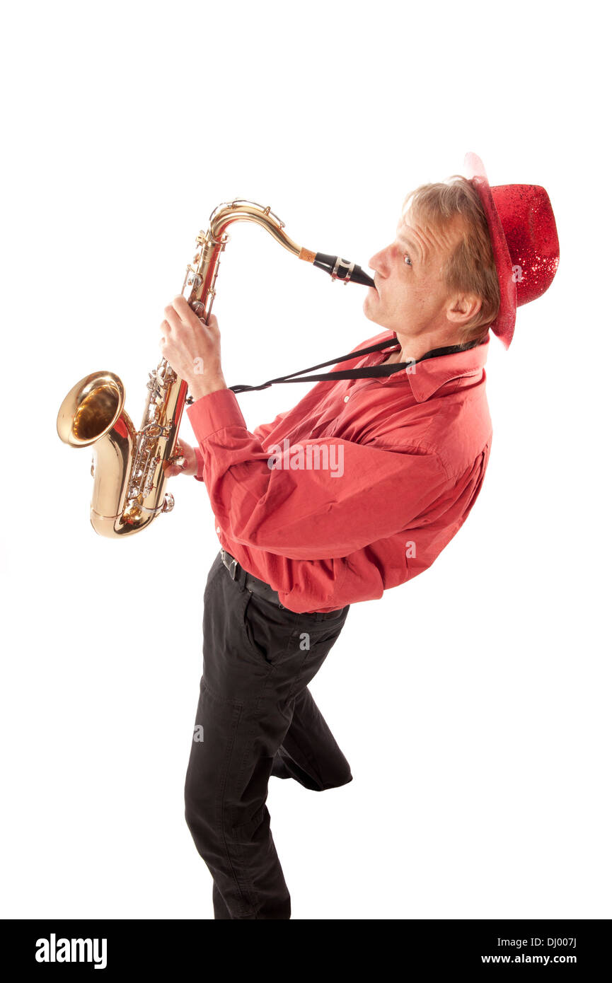 Male artist playing a brass tenor saxophone with silver valves and pearl buttons from above Stock Photo