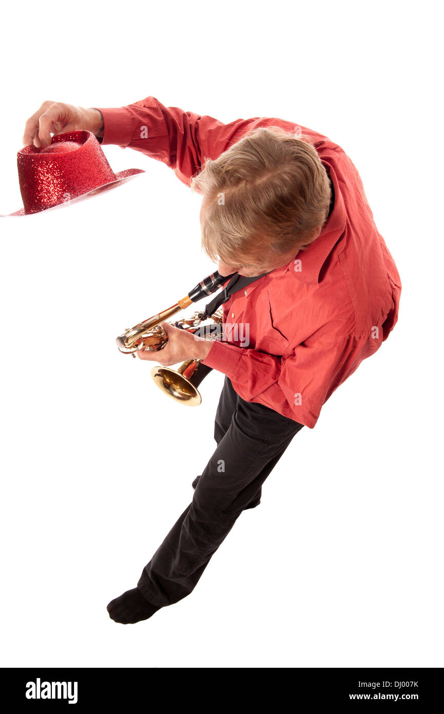 Male artist with hat playing a brass tenor saxophone from above Stock Photo