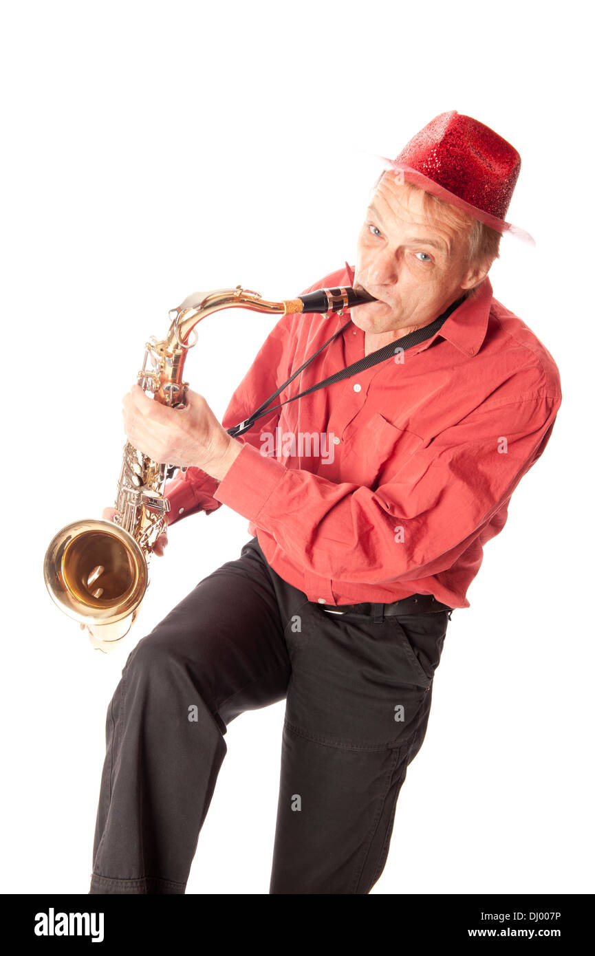 Male performer playing a brass tenor saxophone with silver valves and pearl buttons playfully Stock Photo