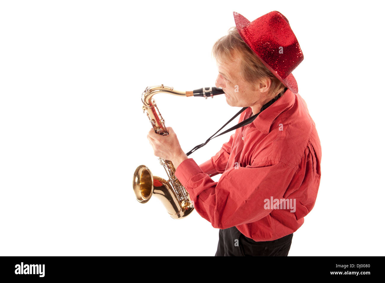 Male performer playing a brass tenor saxophone with silver valves and pearl buttons from above Stock Photo