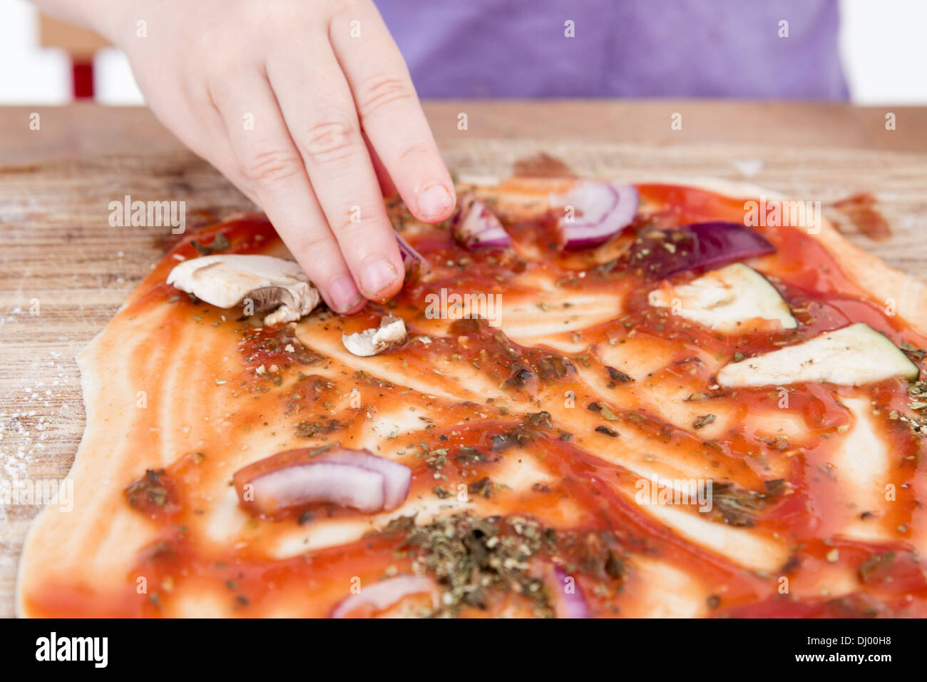 small hands preparing fresh pizza. studio shot. Stock Photo