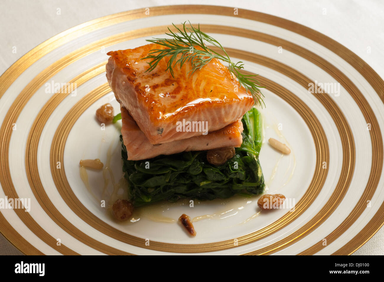 Beer roasted salmon with spinach and raisins Stock Photo