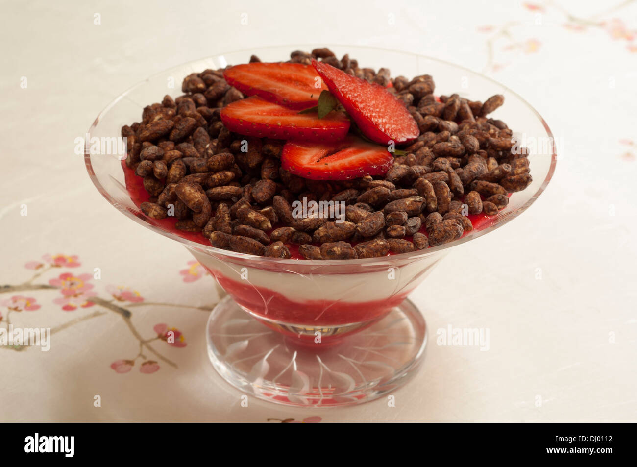 Yoghurt mousse and puffed cereals with strawberry sauce Stock Photo