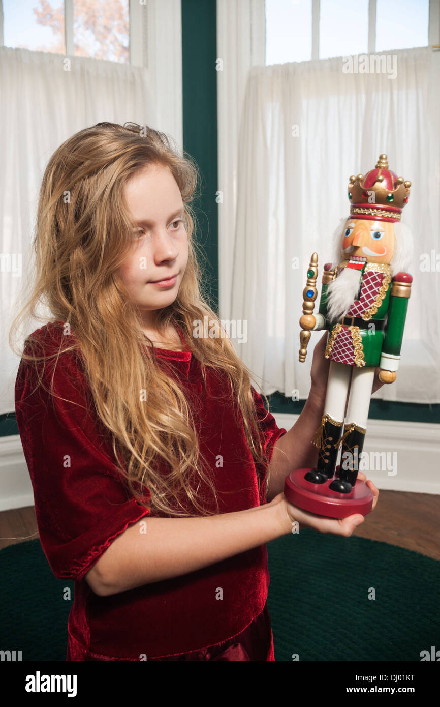 Young girl admires Christmas nutcracker at home, Indiana, USA Stock