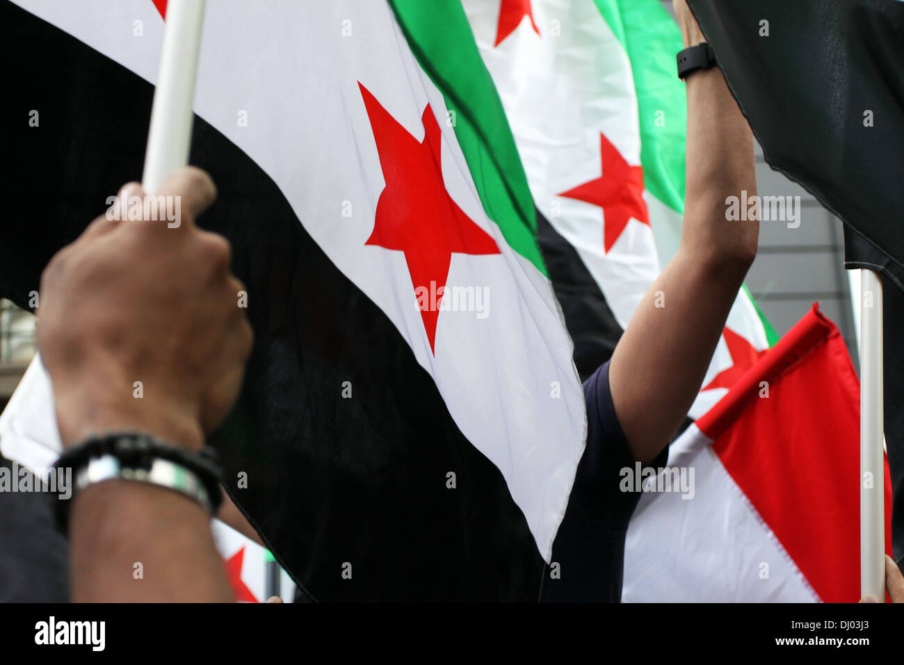 Waving hand Syrian flags Stock Photo