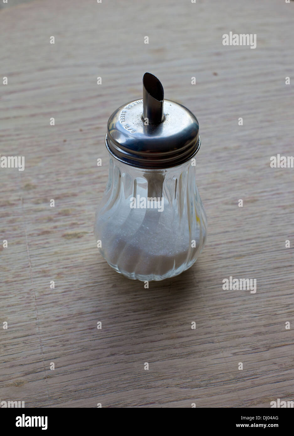 Diner style sugar pourer dispenser on wooden table at posh cafe Stock Photo