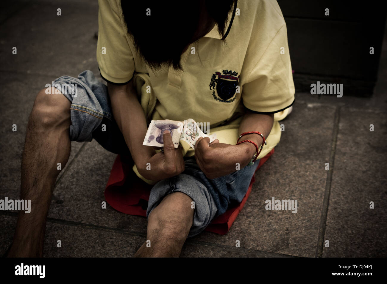 Image taken in Shanghai, China in 2011. Documenting various people on the streets who was constantly begging. Stock Photo