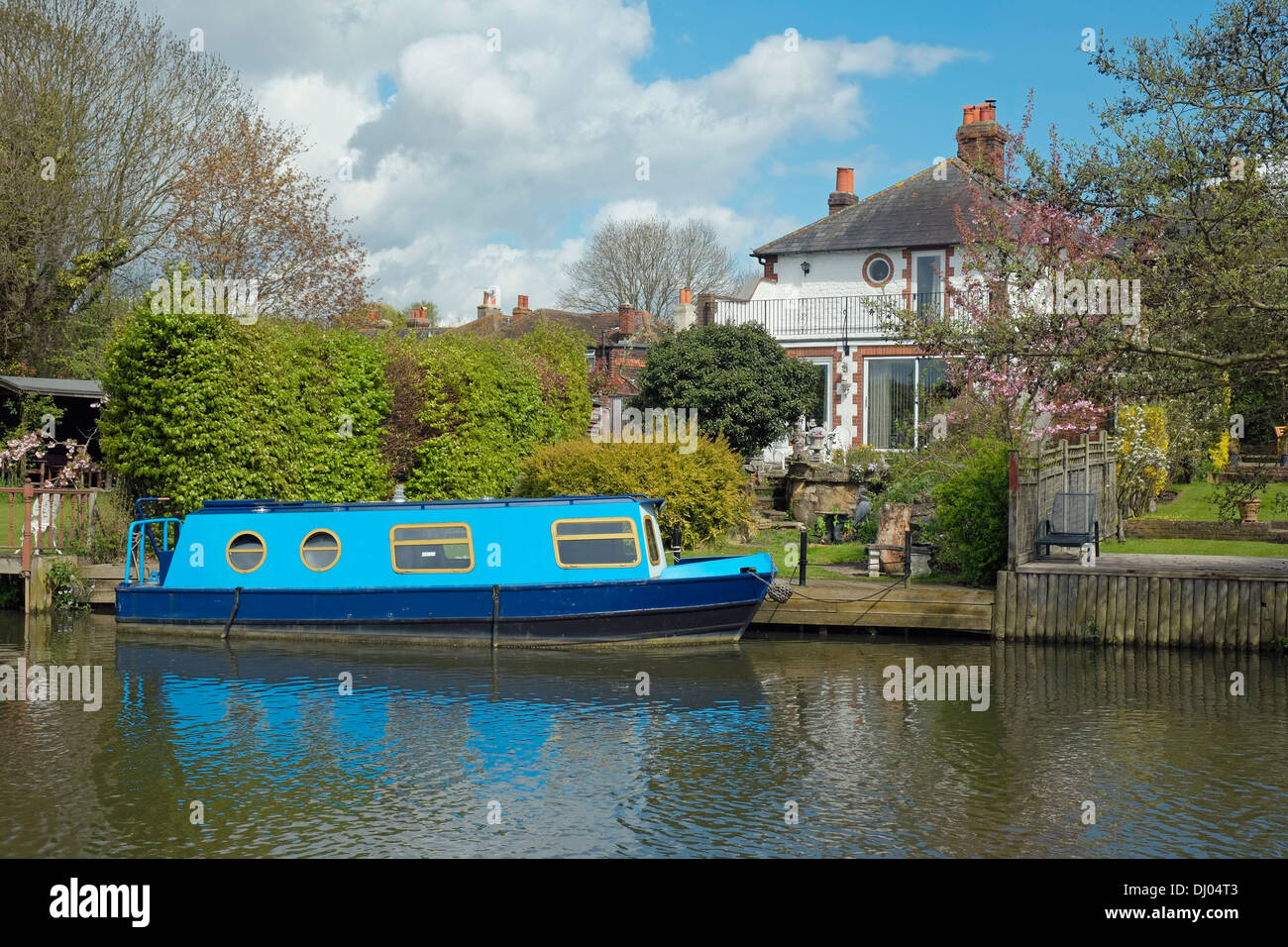 A house with moored narrow boat on the River Wey Navigation, between Guildford and Godalming, Surrey, England. Stock Photo