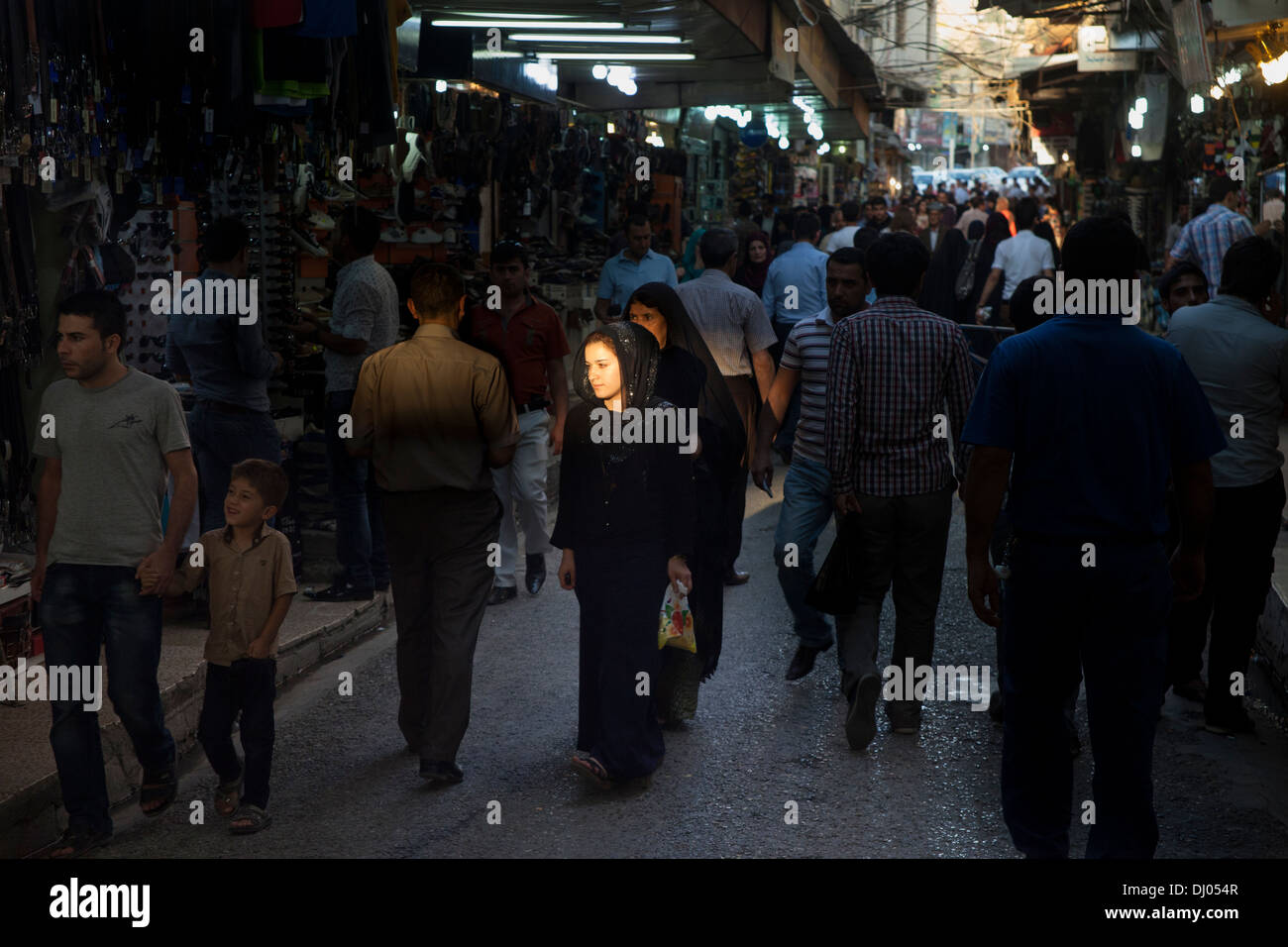 Girle lighted by a ray of sun in the Duhok bazaar Stock Photo - Alamy